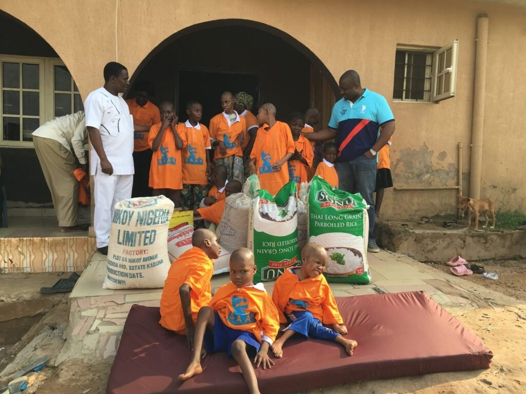 Children at Heaven's Nest orphanage with donated rice, 2016